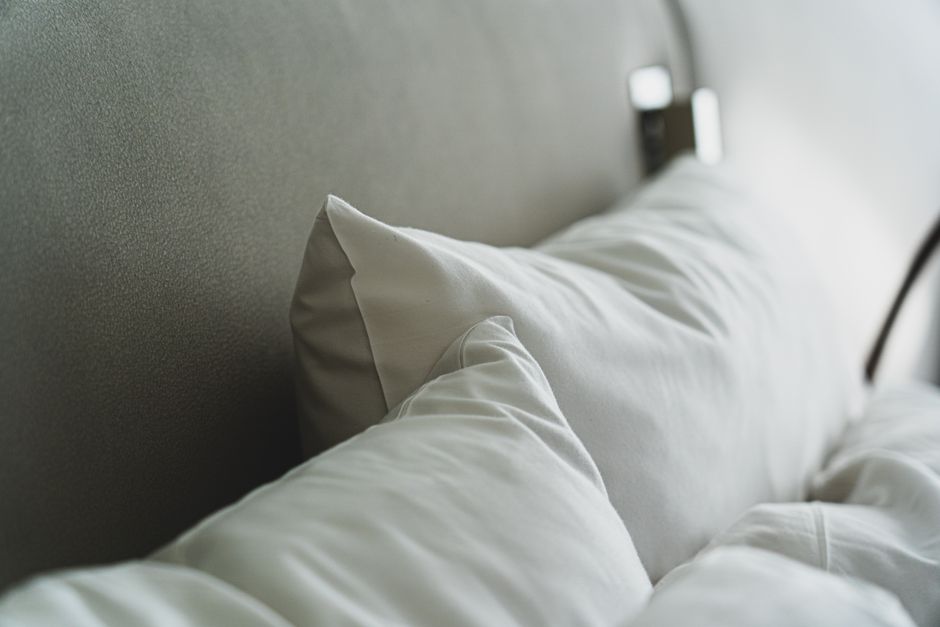 Plump white cooling pillow on a neatly made bed